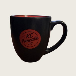 KC Pancake Co. black coffee mug with red interior and red KC Pancake Co. logo