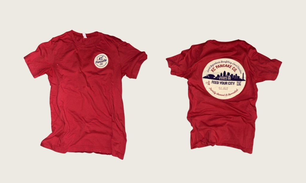 Red KC Pancake Co. Feed Your City t-shirt, front with small logo and back with Kansas City skyline graphic
