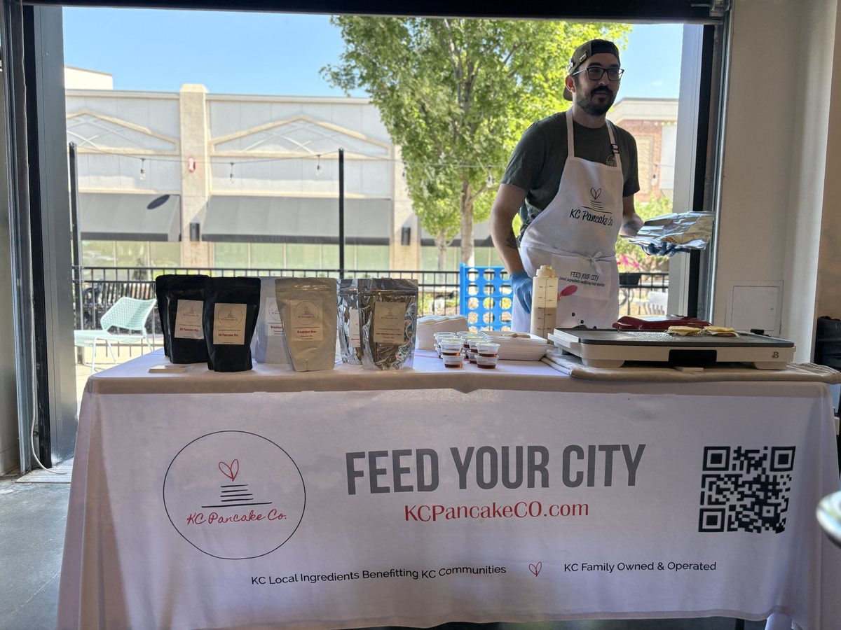 Our early market booth with the Feed Your City tablecloth